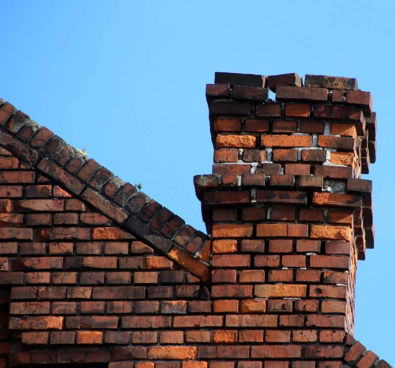 Damaged chimney on an Lake Forest home showing cracks and missing mortar